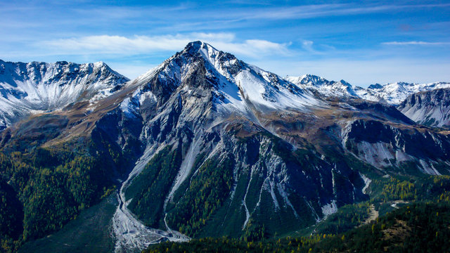 alpine mountain landscape in the late fall with the first snows covering the summit