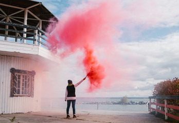 Woman standing on pierce holding torch
