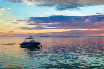 Motorbike against a colorful sunset over the ocean