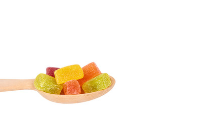 jelly candies in wooden spoon isolated on a white background. copy space, template