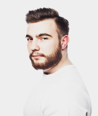 Portrait of a young bearded man in a white T-shirt