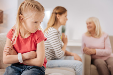 I am angry. Cute sad young girl turning away from her mother and feeling upset while being not allowed to play