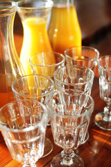 a bottle of orange juice and glasses