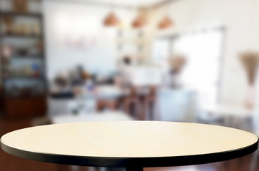 Selected focus empty brown wooden table and Coffee shop or restaurant blur background with bokeh image. for your photomontage or product display.