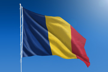 Romania flag in front of a clear blue sky