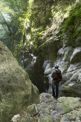 hiker in narrow gorge canyon at matese park gola del torano