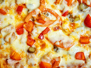 A detailed view of a delicious pizza with vegetables and smoked chicken. Food background.
