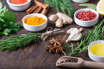 Colorful herbs and spices selection. Aromatic ingredients on wood table