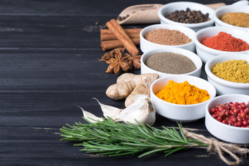 Colorful herbs and spices selection. Aromatic ingredients on wood table