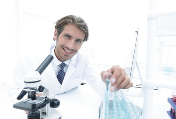 laboratory scientist working in a laboratory with a microscope