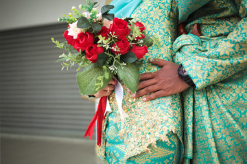 Young married couple holding hands during ceremony wedding day. Selective focus.