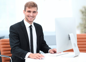 confident businessman sitting at his Desk.