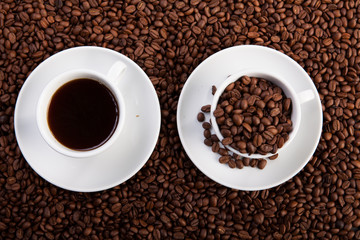 white cup of coffee at coffee beans backgrounds