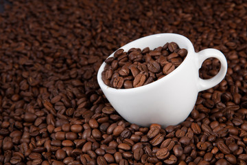 white cup of coffee at coffee beans backgrounds