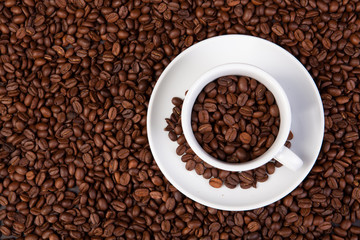 white cup of coffee at coffee beans backgrounds