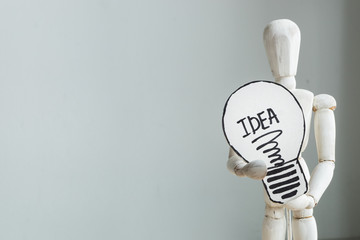 Creative idea concept of idea and innovation with wooden model holding draw lightbulb paper. Copy space