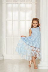 Obraz na płótnie Canvas Little cute girl in a blue dress
