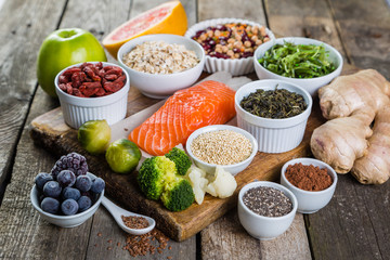 Selection of superfoods on rustic background