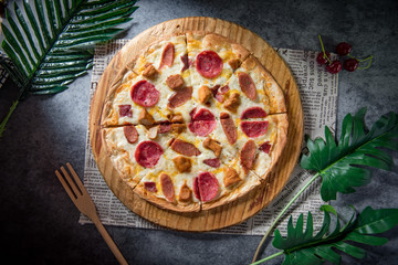 Pizza and red wine on wooden rustic table, top view.