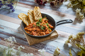 Sprat in tomato sauce, top view, rustic.