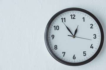 black clock on white wall with copy space