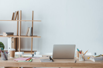 interior of room with copybooks and laptop on table