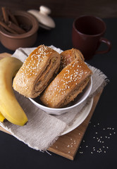 Scones from whole-grain flour/ Scones from whole-grain flour with a banana on a dark background