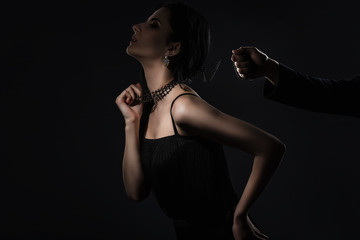 Male hand holds a sensual woman in collar. dominance concept
