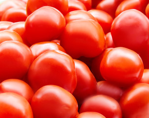 Red fresh ripe tomatoes close up in the supermarket. Vegetables harvest