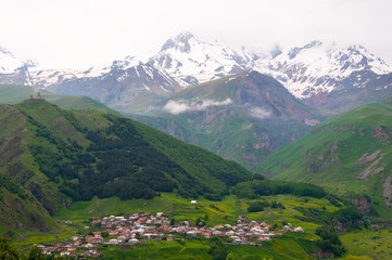 Fototapeta na wymiar Panoramic beautiful view of the Stepantsminda village in the mountains. Georgia