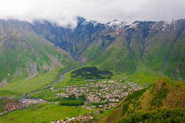 Fototapeta premium Panoramic beautiful view of the Stepantsminda village in the mountains. Georgia
