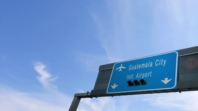 airplane flying over guatemala city airport signboard