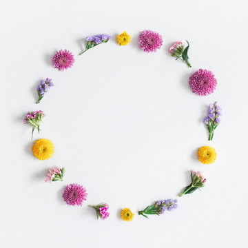Flowers composition. Wreath made of colorful flowers on gray background. Flat lay, top view, square, copy space