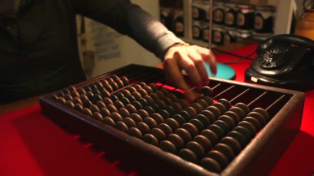 Man calling the old phone, wooden abacus in the office