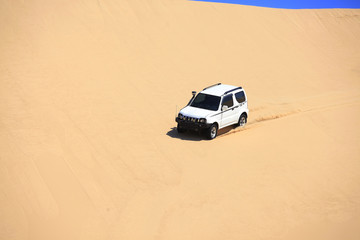 Fototapeta na wymiar An suv was driving in the desert.