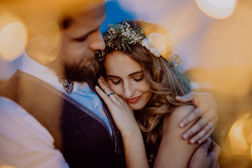 Beautiful bride and groom on a meadow at night.