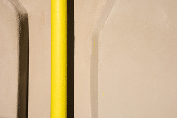 Background with a yellow bright industrial pipe