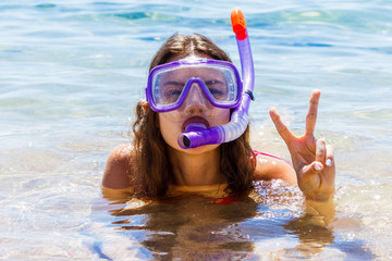 young teenager girl at the seaside wearing a diving mask