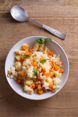 Healthy food: rice porridge with pumpkin, apples and raisins. Vegetarian or diet dish of rice and pumpkin good for breakfast. View from above, top