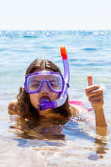 Snorkel girl with glasses and a tube for swimming on summer vacation