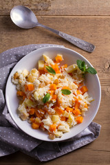 Healthy food: rice porridge with pumpkin, apples and raisins. Vegetarian or diet dish of rice and pumpkin good for breakfast. View from above, top