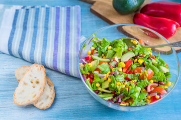 Traditional Vegetarian American Southwest Salad with vegetables, beans and corn on a rustic background