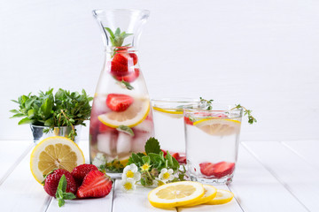 Fruit and herb infused water. Cold refreshing vitamin detox water. Summer drink
