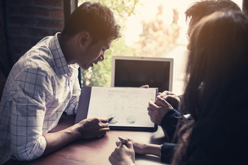 Discussing plan and idea to improvement strategy, businessmen brainstorming for strategy of business investment,businessmen review chart and document of investment information.