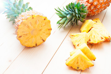 Pineapples cut and slice on wooden table