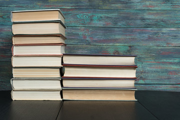 Stack books on wooden background. Back to school with copy space.