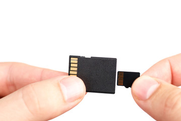 Small Flash card in hand isolated on white background.