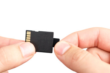 Small Flash card in hand isolated on white background.