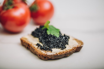 Black caviar on a slice of bread