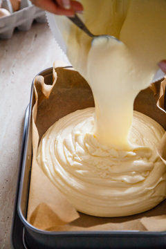 Woman preparing cheesecake on table